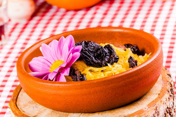 Stewed cabbage with prunes in ceramic dish