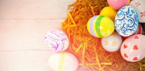 Painted Easter eggs against blue wood background 