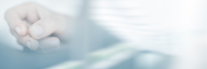 Woman holding needle in acupuncture therapy