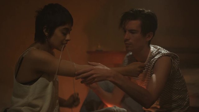  Drug addict couple in gloomy apartment taking heroin together