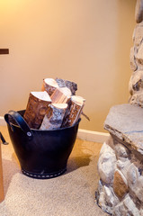 Stylish Bucket full of Firewood by a Fireplace