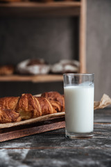 Pastries on wooden table with milk