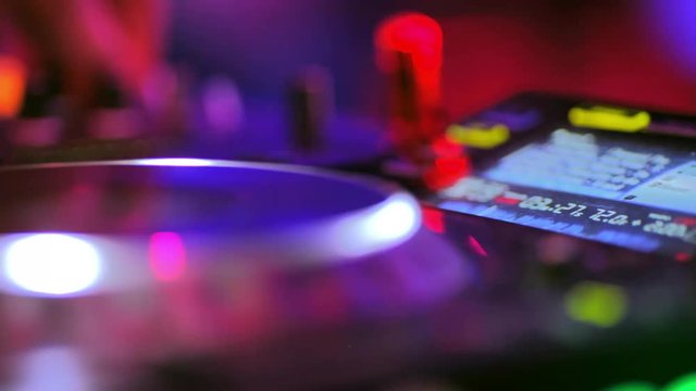 club DJ playing on turntables.