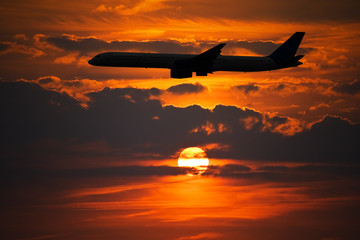 Plane Silhouette against Sunset Sky