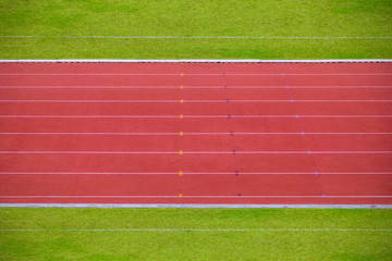 Running track lanes with green grass