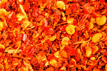 Dry crushed chili flakes. Food background. Closeup macro shot. Top view.