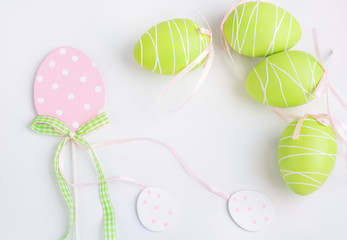 Easter pastel eggs decor on white background. Space for your text. Top view.