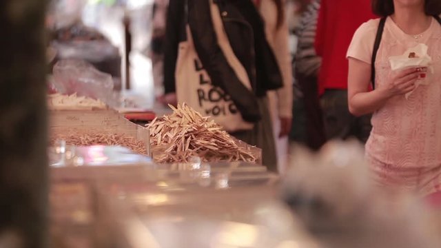 Dried squids and other dehydrated and desalted foods in a market on Dihua Street, a famous commercial place in Taipei, Taiwan. People are walking around.