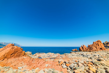 Fototapeta na wymiar Red rocks beach under a blue sky