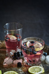 two glasses of blueberry and lemon drink with ice