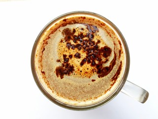 Top view and closeup of a glass of coffee on white background.