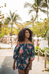 Naklejka premium Fashion woman walking on beach with a summer dress