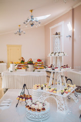 Candy bar on wedding ceremony with a lot of different candies and beverages
