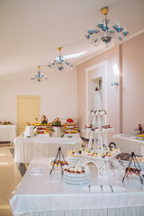 Candy bar on wedding ceremony with a lot of different candies and beverages