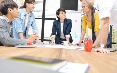 Group of businesspersons having different age in creative business discussing work in the office