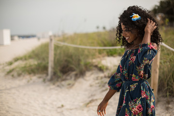 Fashion woman walking on beach with a summer dress