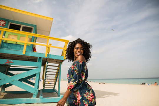 Fashion woman walking on beach with a summer dress