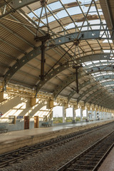 Fototapeta na wymiar Narrow view of a locomotive electric train station platform with covered tunnel, Chennai, India, Mar 29 2017
