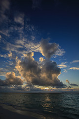 Naklejka na ściany i meble Sunset in clouds on the sea coast, Maldives