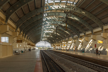 Naklejka na ściany i meble Wide view of a locomotive electric train station platform with covered tunnel, Chennai, India, Mar 29 2017
