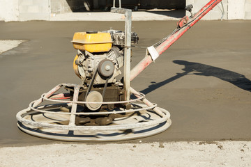 Working power trowel machine on a fresh concrete surface