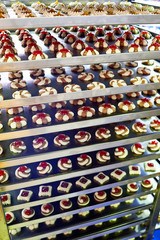 Cookies on metal shelves in confectionery factory