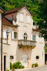 Fototapeta na wymiar Balcony with columns in an old house. Balkan architecture. Montenegrin balconies