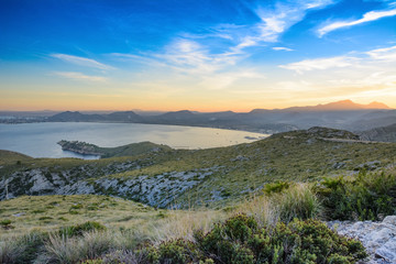 This view is near the city of Port de Pollenca. View of a beautiful landscape is near a road on a hill.