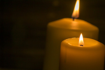 a candle is lit in the darkness