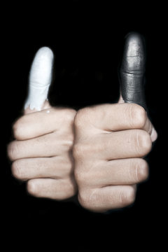 Black and white colored thumbs.Concept of genderinequality.