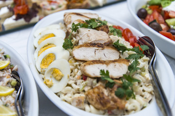 Colorful canape with vegetables and sausage on a slate plate