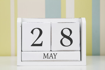 Cube shape calendar for MAY 28 on white table. 