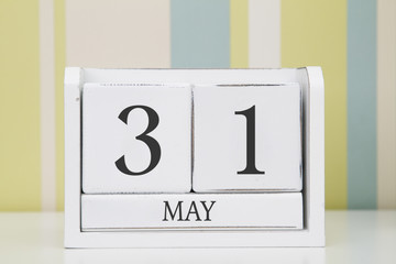 Cube shape calendar for MAY 31 on white table. 