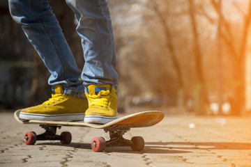 young skateboarder legs skateboarding at skatepark