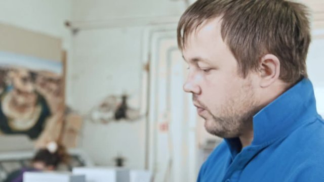 Close yp of working man at printing factory - typography