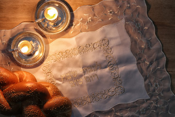 shabbat image. challah bread, shabbat wine and candelas