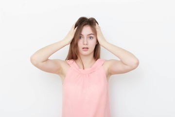 Young casual woman In pink blouse isolated over white background studio portrait