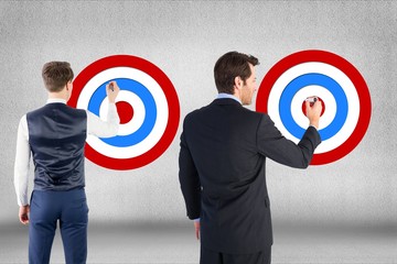 Rear view of businessmen setting targets on wall