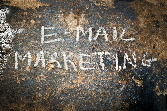 E-Mail text written a brown and rough surface.