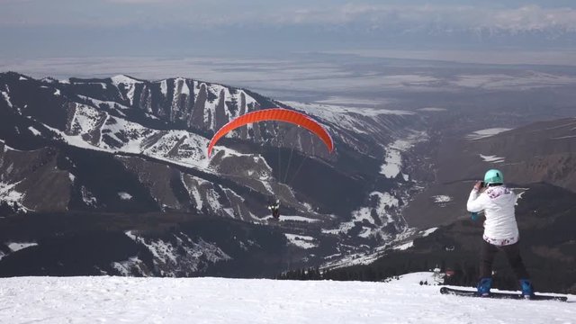 Paraglider take off against the backdrop of beautiful mountains