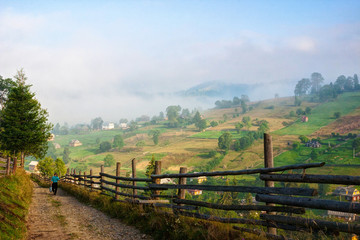 Fototapeta na wymiar Country Road at sunny morning, Vorokhta, Carpathian Mountains, Ukraine.