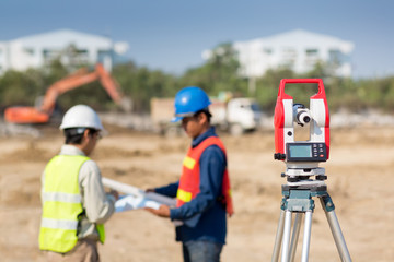 Civil Engineers At Construction Site and A land surveyor using an altometer