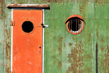 Old rusty door and window on an old ship