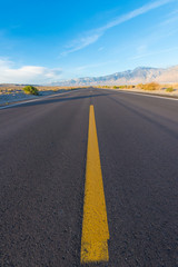 Fototapeta na wymiar Yellow line in middle of road in desert