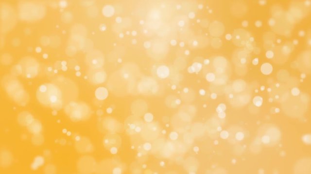 Beautiful golden yellow background with glowing light particles creating a bokeh effect.