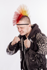 Portrait of punk rocker with Mohawk with clenched fists ready to fight  on a white background.