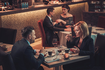 Stylish wealthy couple in a restaurant.