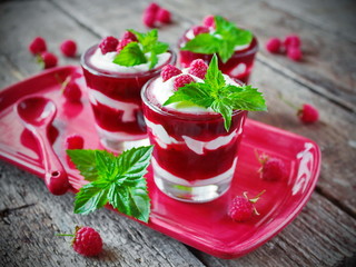 Raspberry dessert with cream in a glass