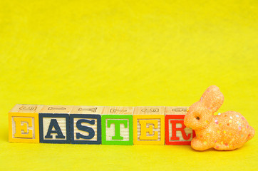 Easter spelled with alphabet blocks and an orange bunny