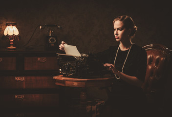 Beautiful young woman typing in retro interior